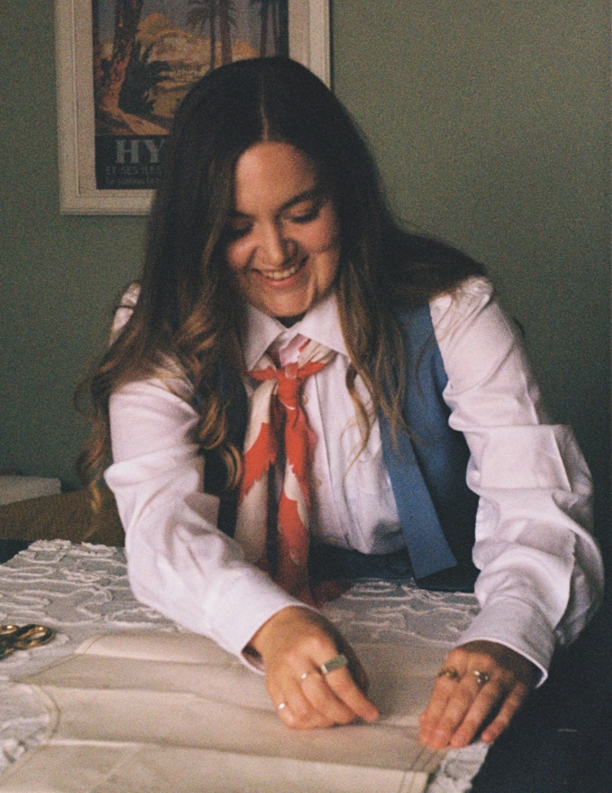 Picture of Ailsa Lyall sewing on a table.